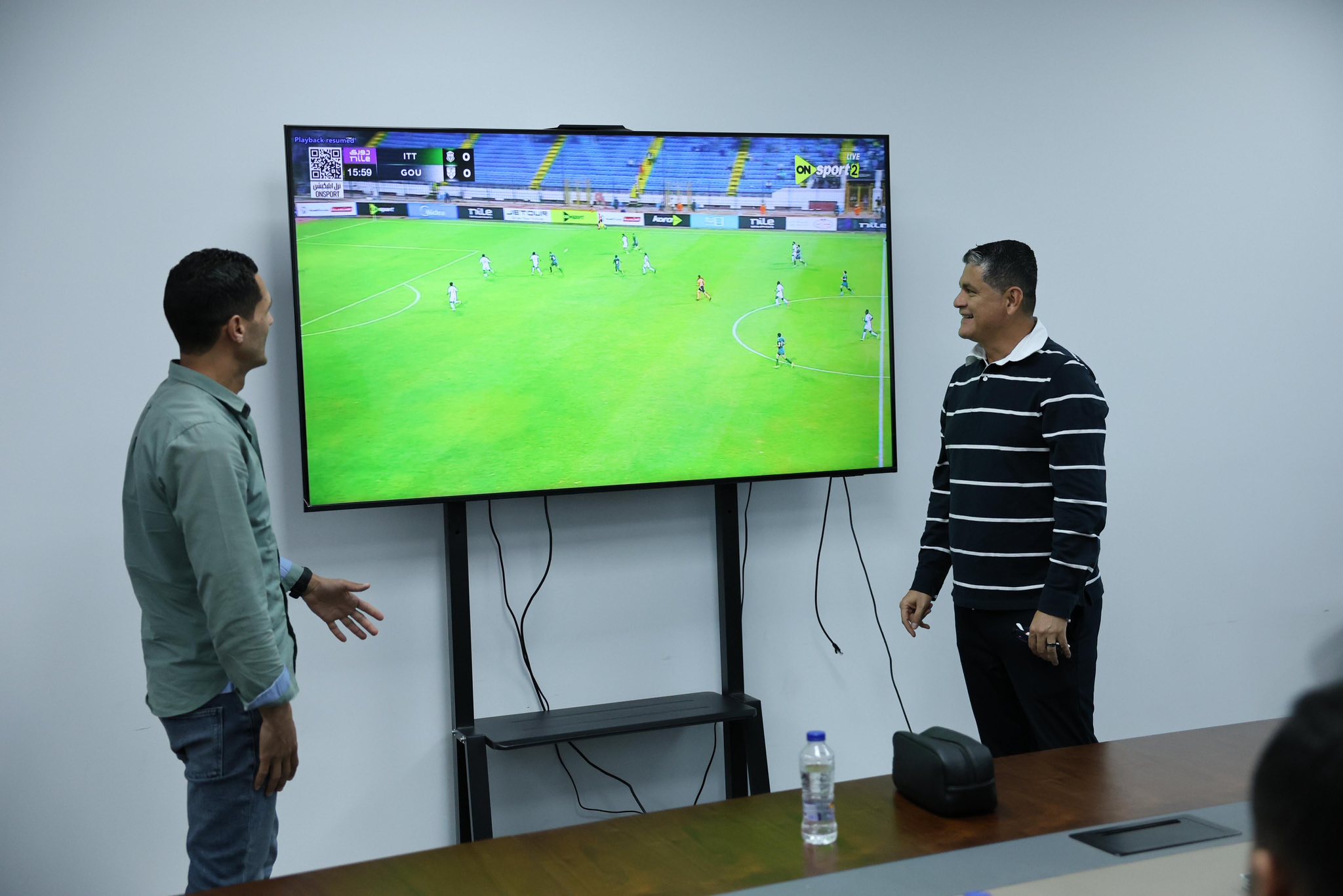 May be an image of football, soccer, television and text